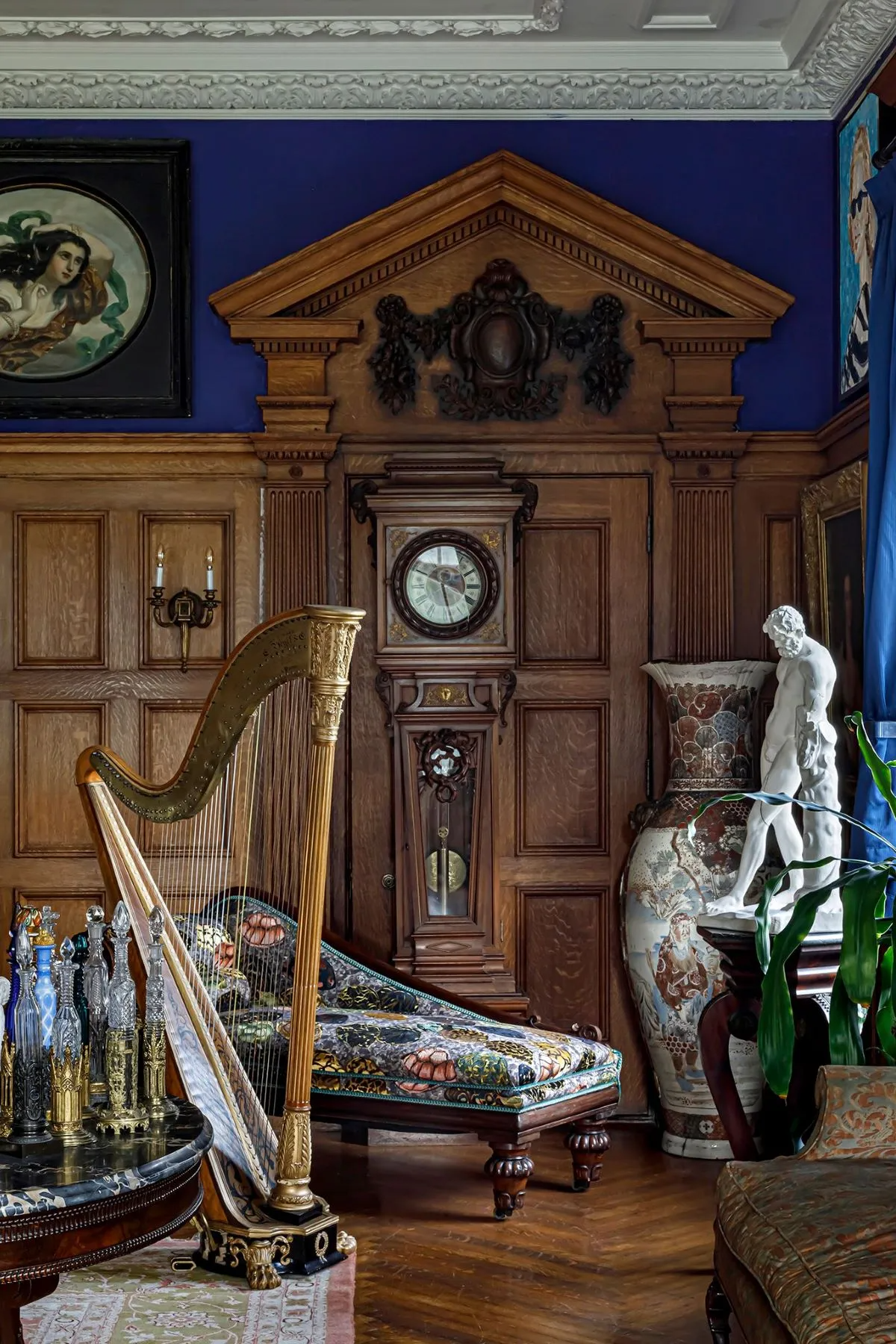 parlor with wainscoting, bright blue walls, plasterwork