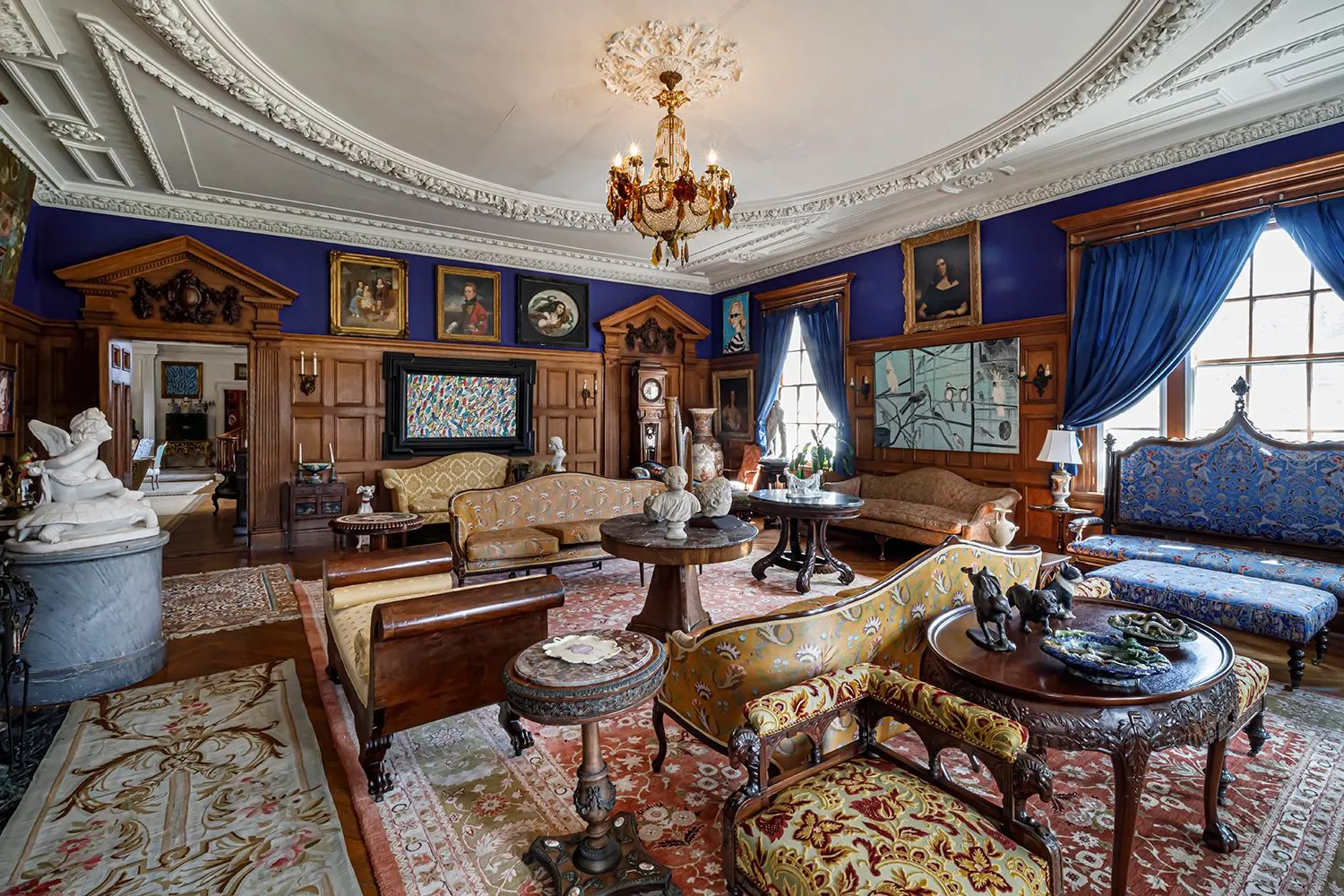 parlor with wainscoting, bright blue walls, plasterwork