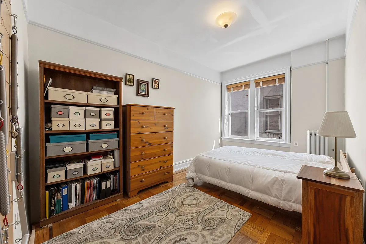bedroom with wood floor, picture rails