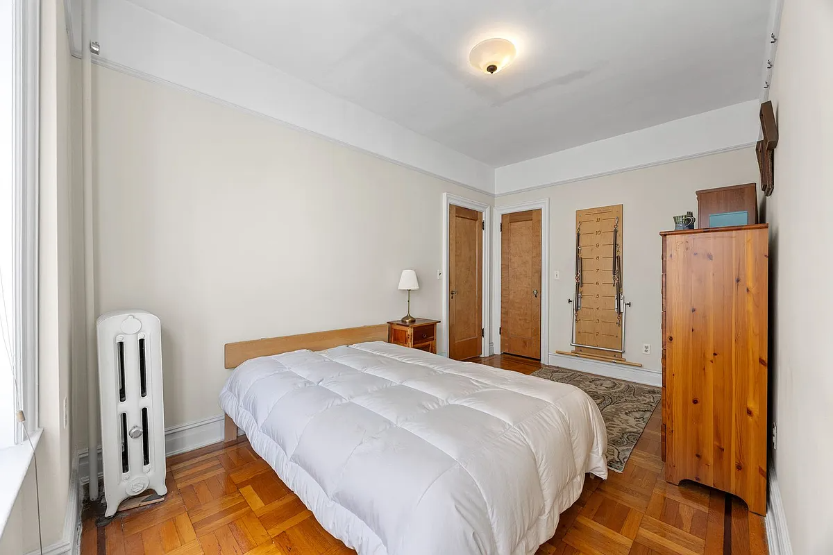 bedroom with wood floor, picture rails