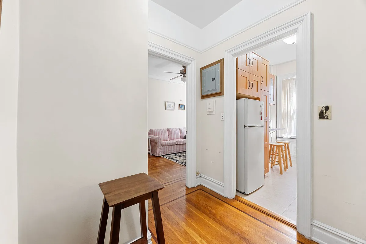 foyer with wood floor and view into the kitchen