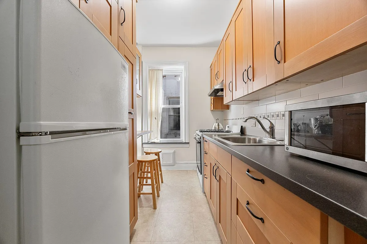 kitchen with wood cabinets, beige tile floor