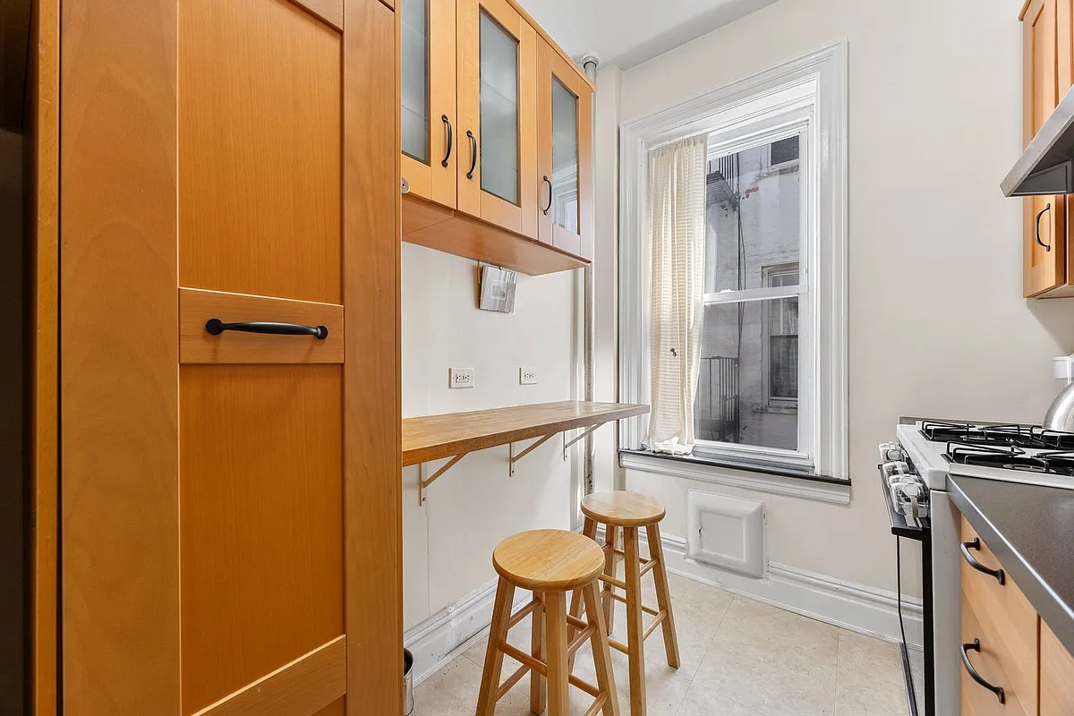 kitchen with wood cabinets, beige tile floor