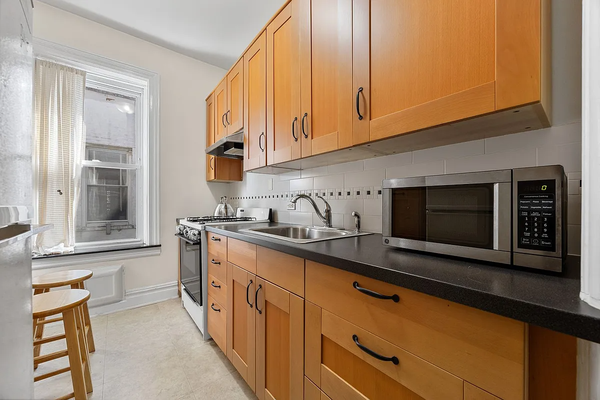 kitchen with wood cabinets, beige tile floor