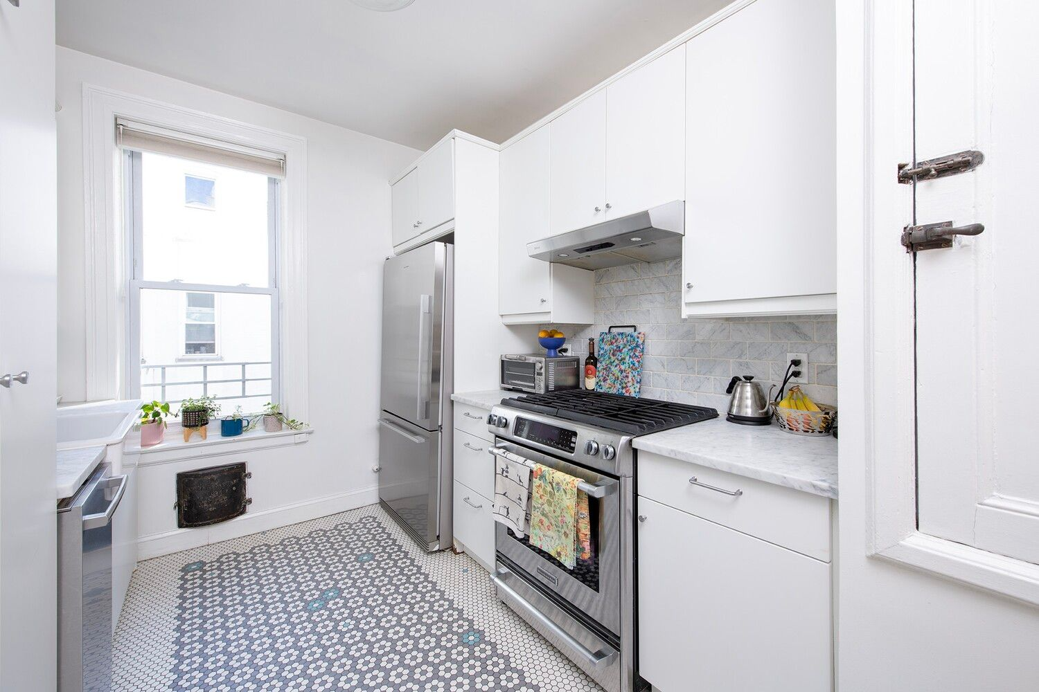 kitchen with decorative hex tile floor, white cabinets