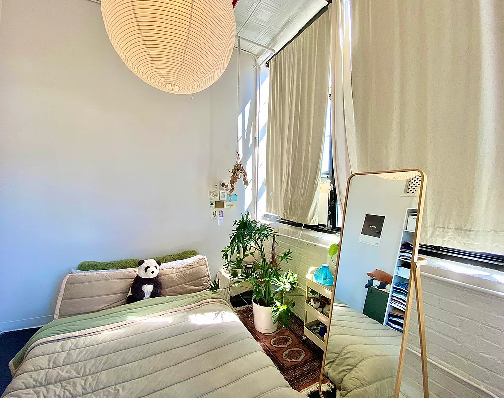 bedroom with large windows, tin ceiling