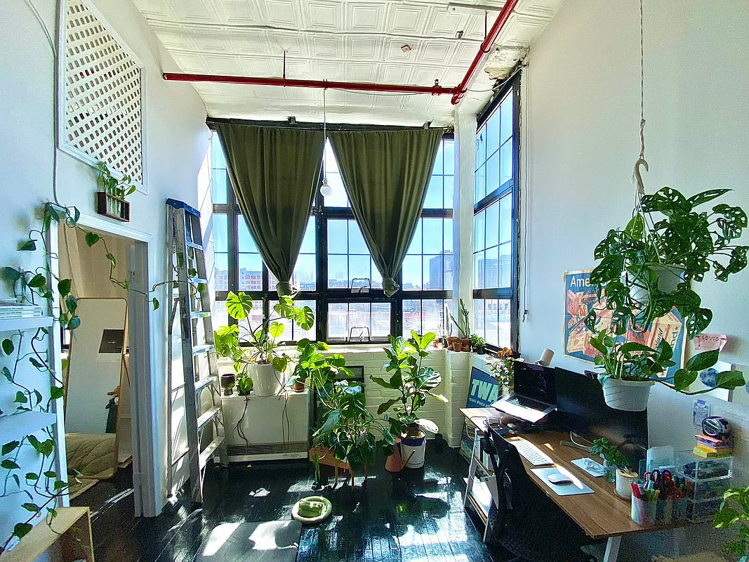 living area with corner windows, tin ceiling