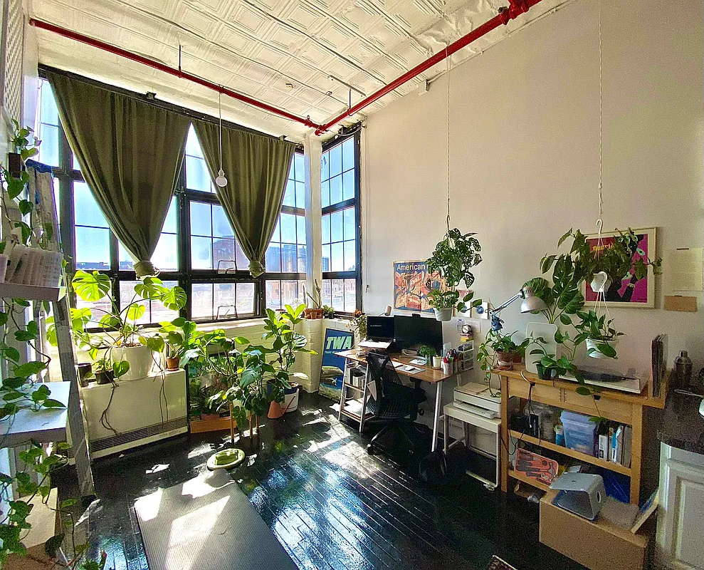 living area with corner windows, tin ceiling