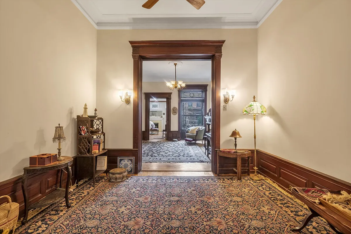 middle parlor with moldings, ceiling fan