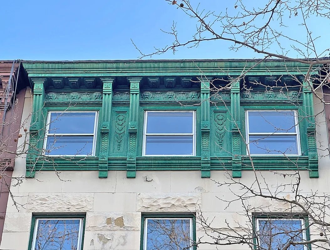 green cornice of a terraced house with brackets