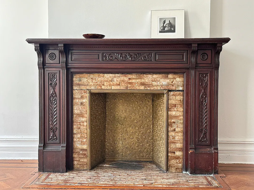wooden fireplace with original tile edge