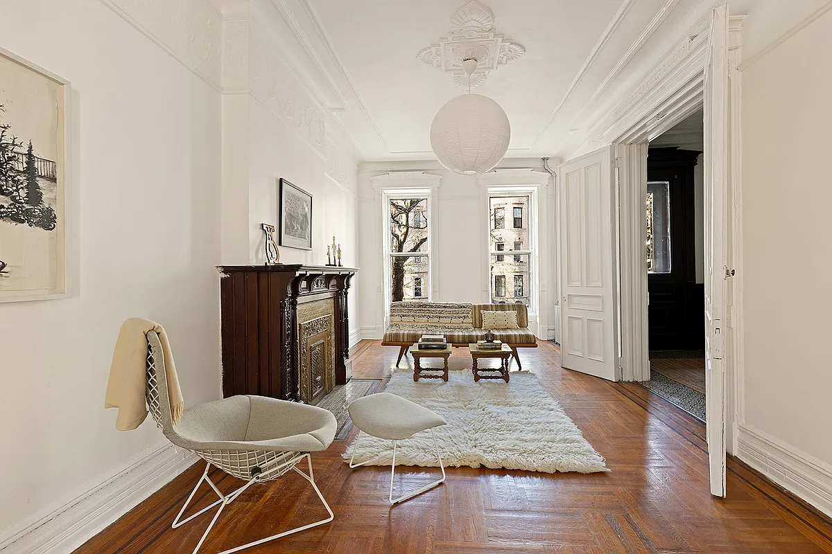 parlor with wood floor, mantel