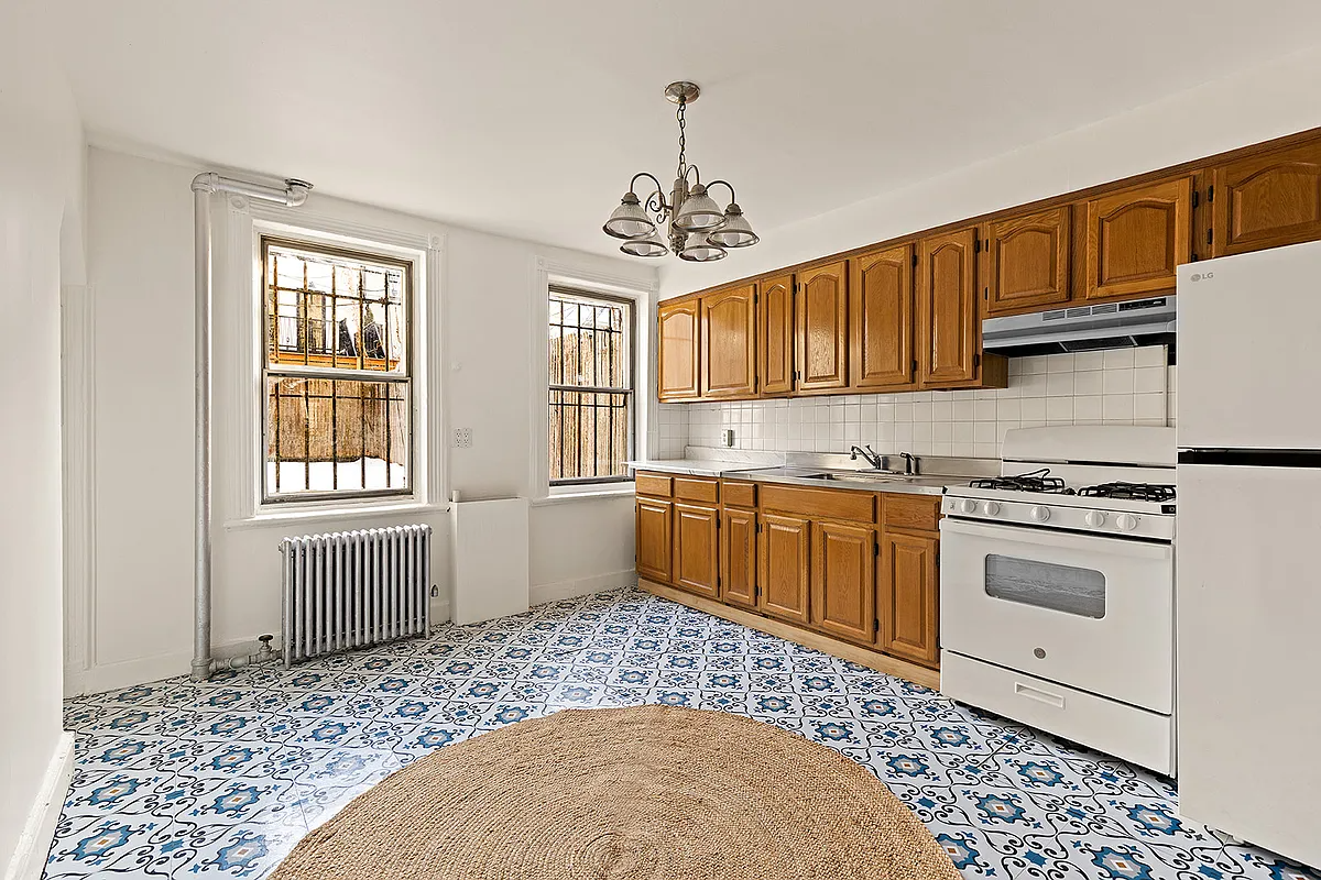 kitchen with tiled floor with blue pattern, wooden cabinets
