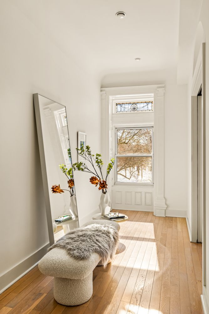 bedroom with pale wood floor, white walls