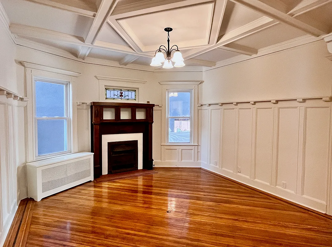 dining room with beamed ceiling, mantel
