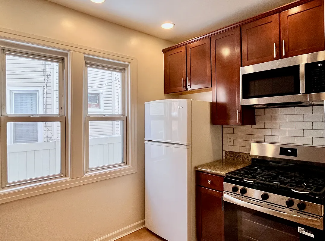 kitchen with wood cabinets, white fridge