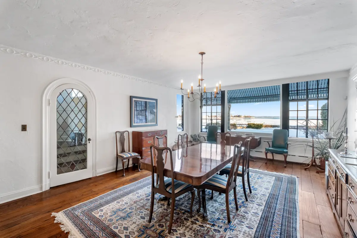 dining room with arched doorway, plaster details, large windows