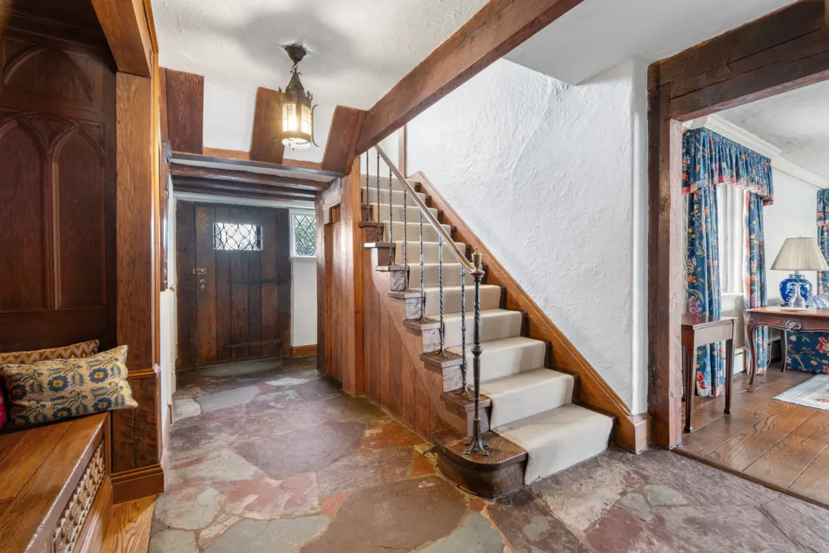 entry with stone floor, built-in bench