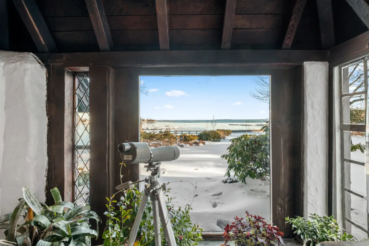 wood framed window in den with view to water