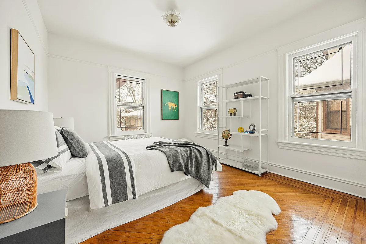 bedroom with wood floor and two exposures