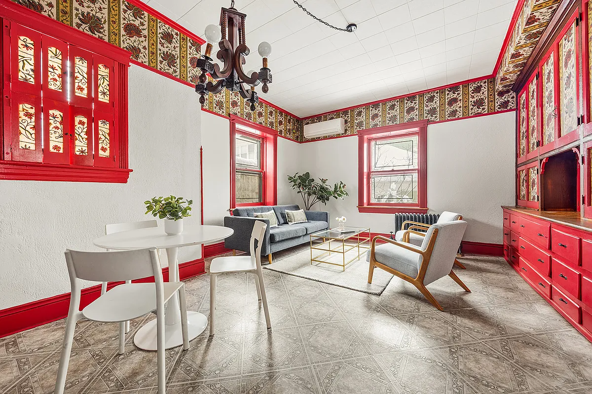an informal dining space with a built-in hutch painted red