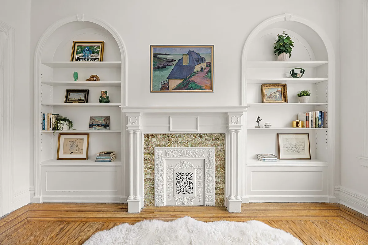 bedroom with arched niches, white mantel