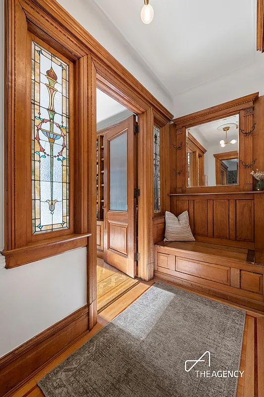 entry hall with built-in bench, stained glass