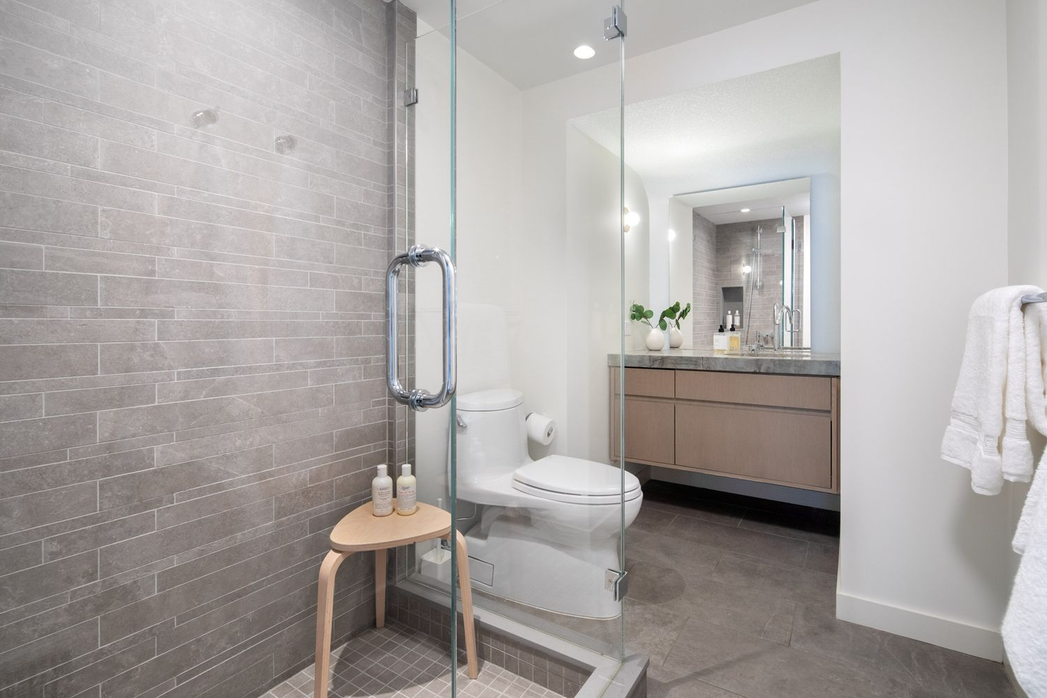 bathroom with shower, beige tile
