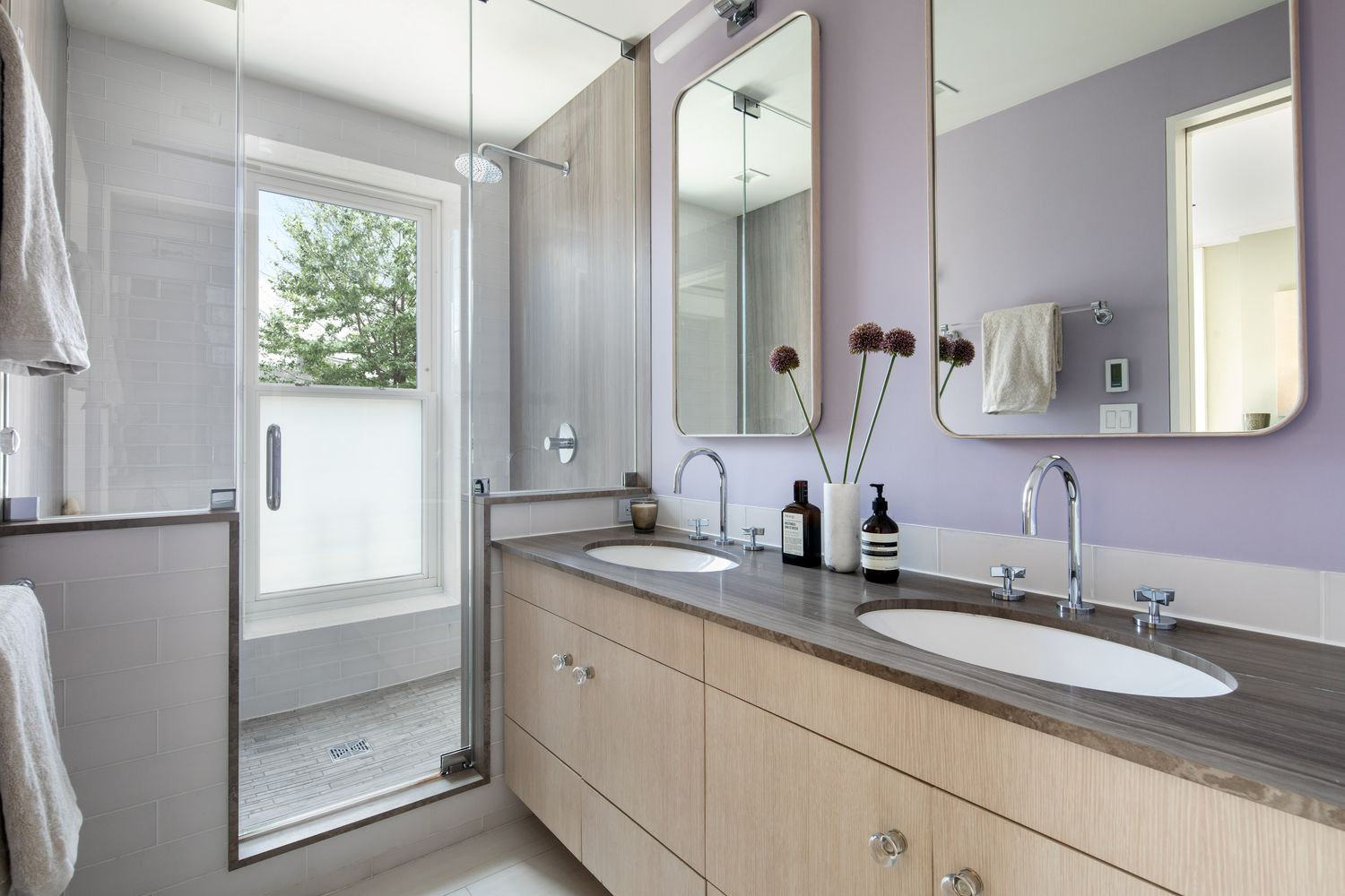 bathroom with double vanity and walk-in shower