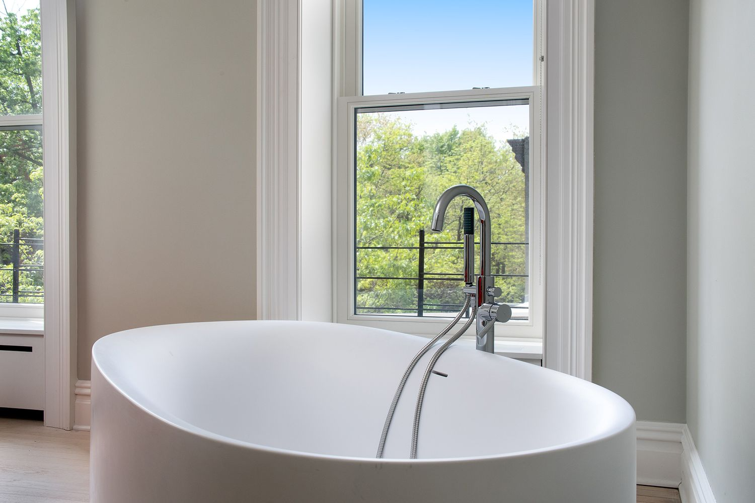 dressing room with modern mantel and a soaking tub