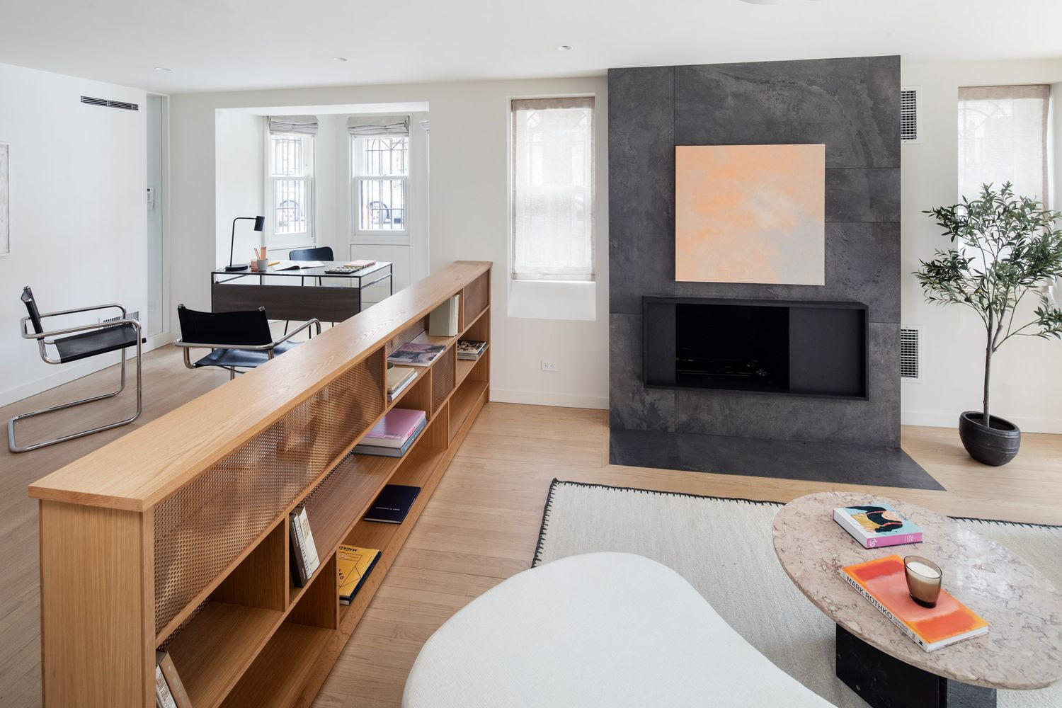 garden level living room with office nook and a modern mantel wall