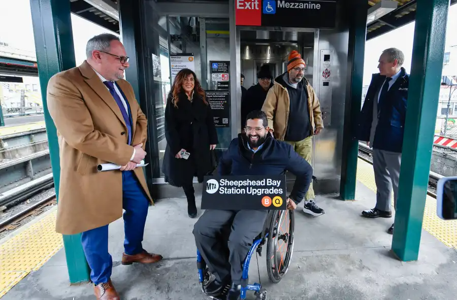 people at an elevator on a subway platform