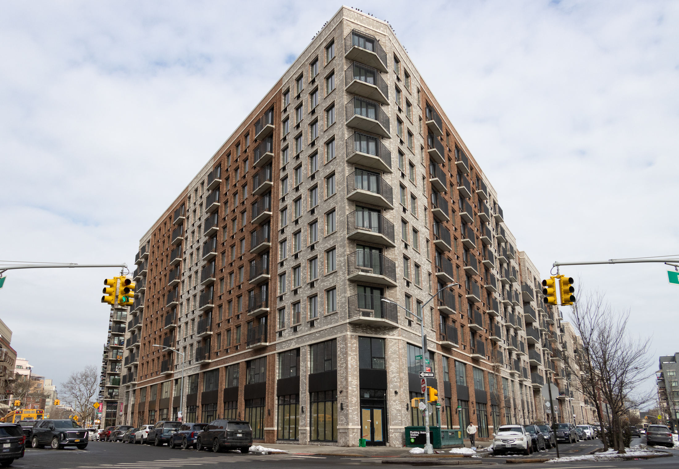 new corner brick building with commercial street level and housing above
