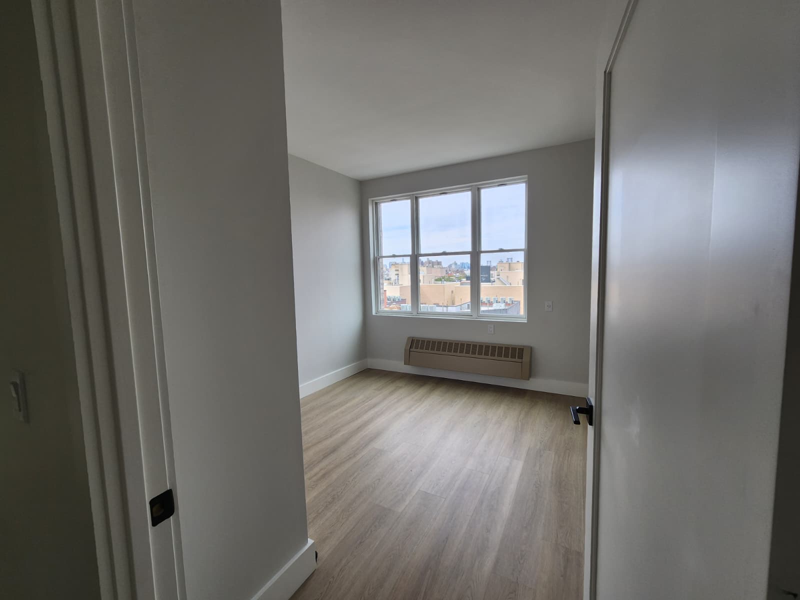 room with a window, wall mounted radiator