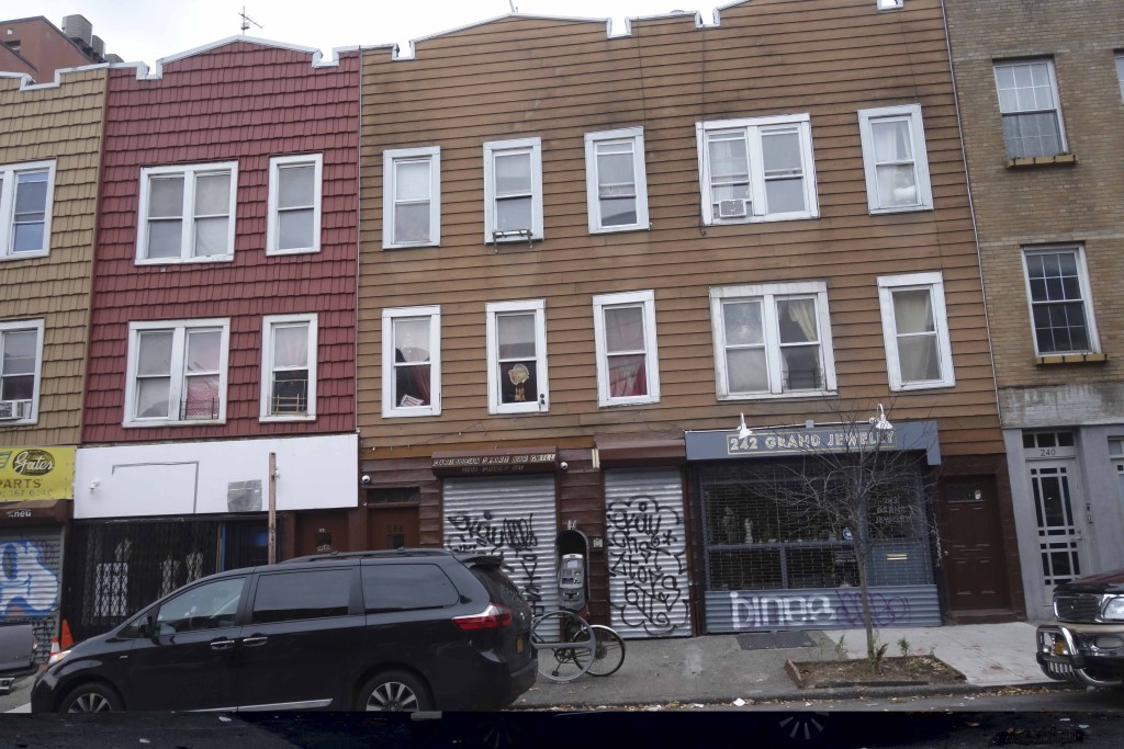 low scale building with gated storefront