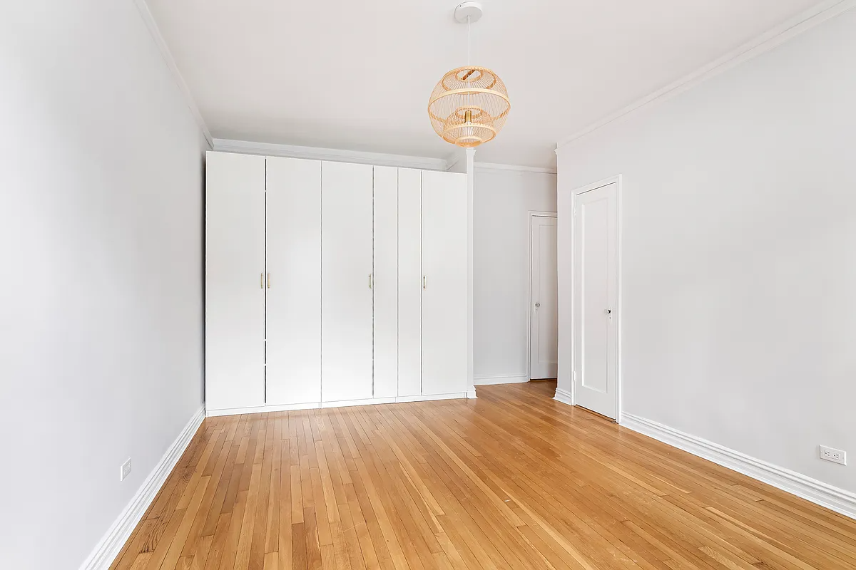 bedroom with wall of storage