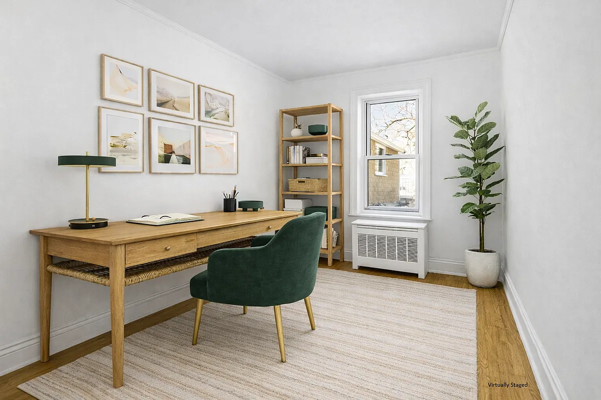 bedroom set up as an office with desk and bookcase