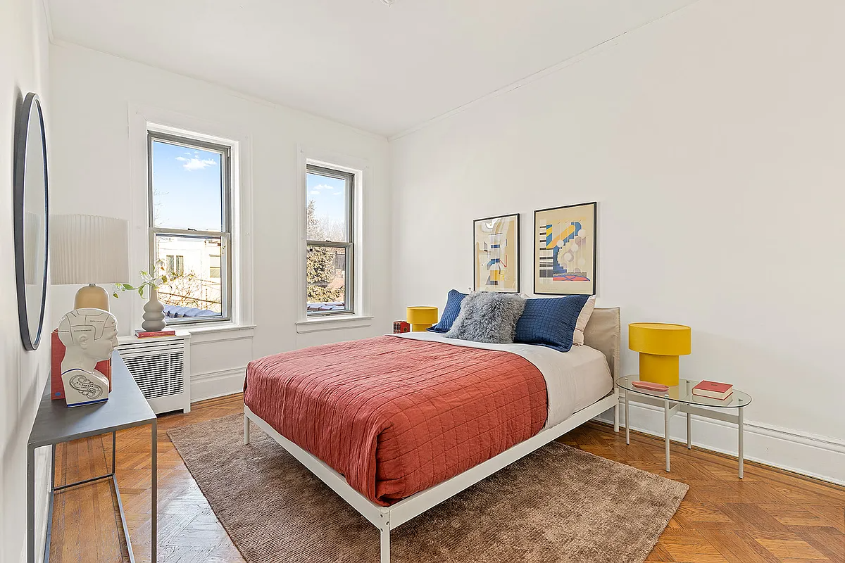 bedroom with two windows, wood floor