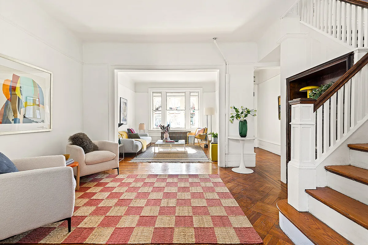 living room with wood floor, stair, white walls