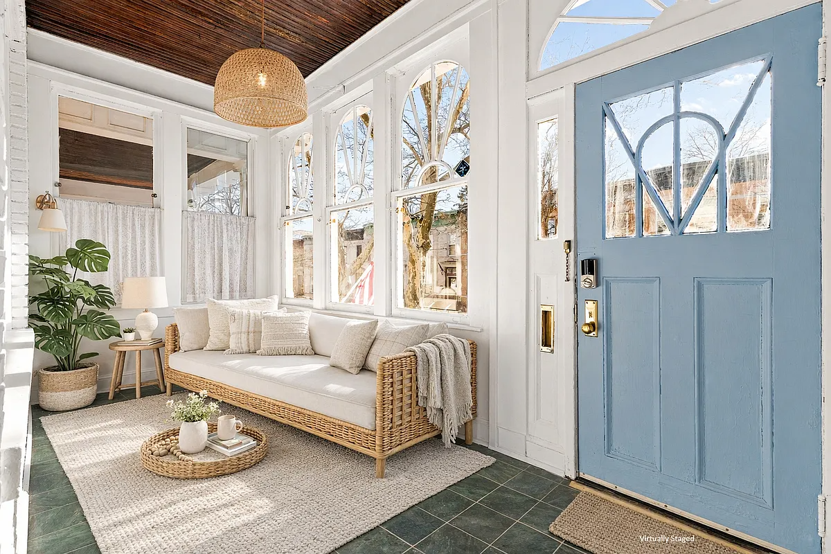 virtually staged enclosed porch with sofa, green tile floor