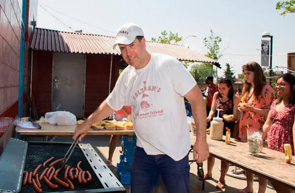 person making hot dogs
