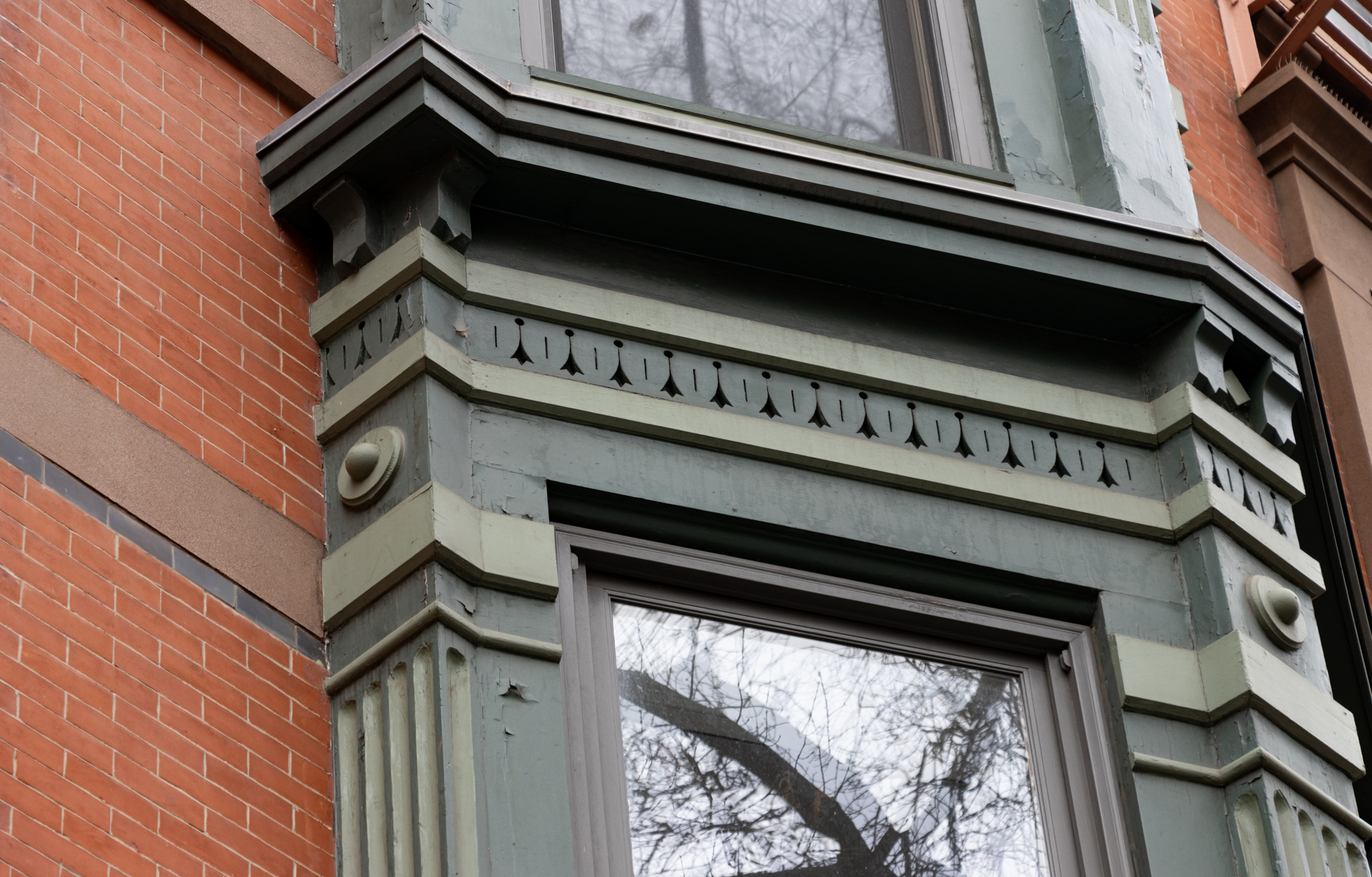 wooden bay on a brick building