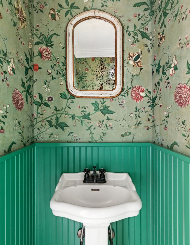 powder room with green wainscoting, floral wallpaper