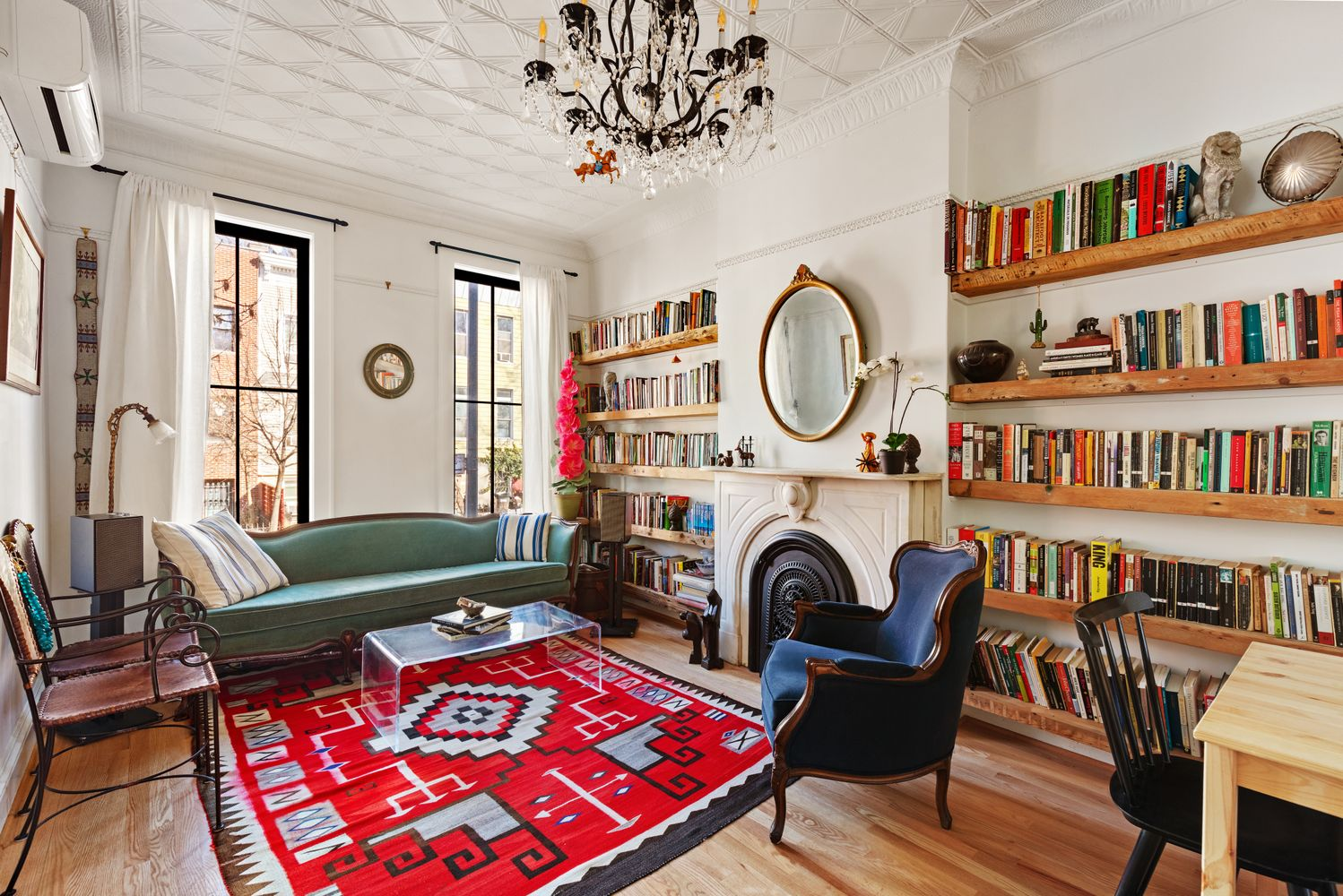 parlor with white walls, tin ceiling, marble mantel