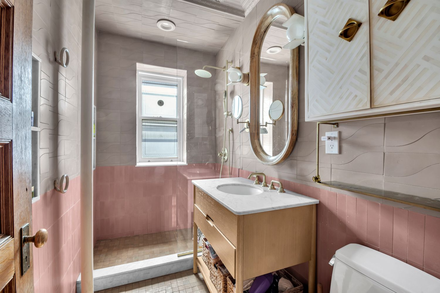 bathroom with walk-in shower, pink and beige tiles