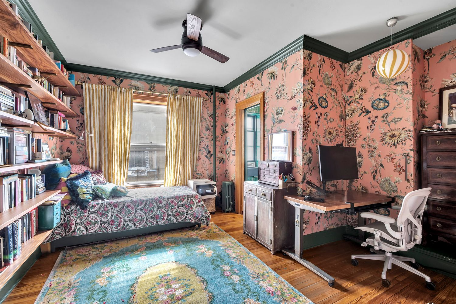 bedroom with oversized pink, floral wallpaper
