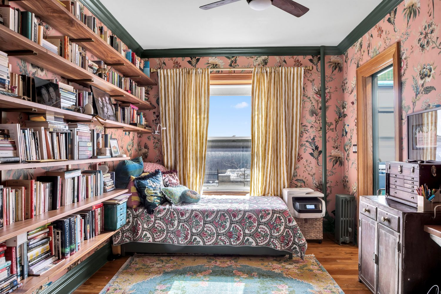 bedroom with oversized pink, floral wallpaper