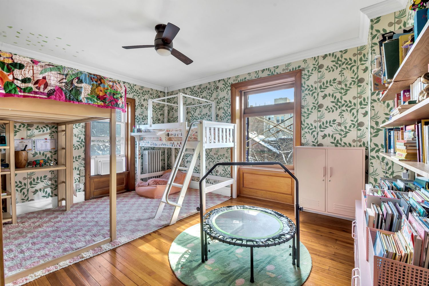 bedroom with floral wallpaper, wood floor set up as a childrens room with a loft beds