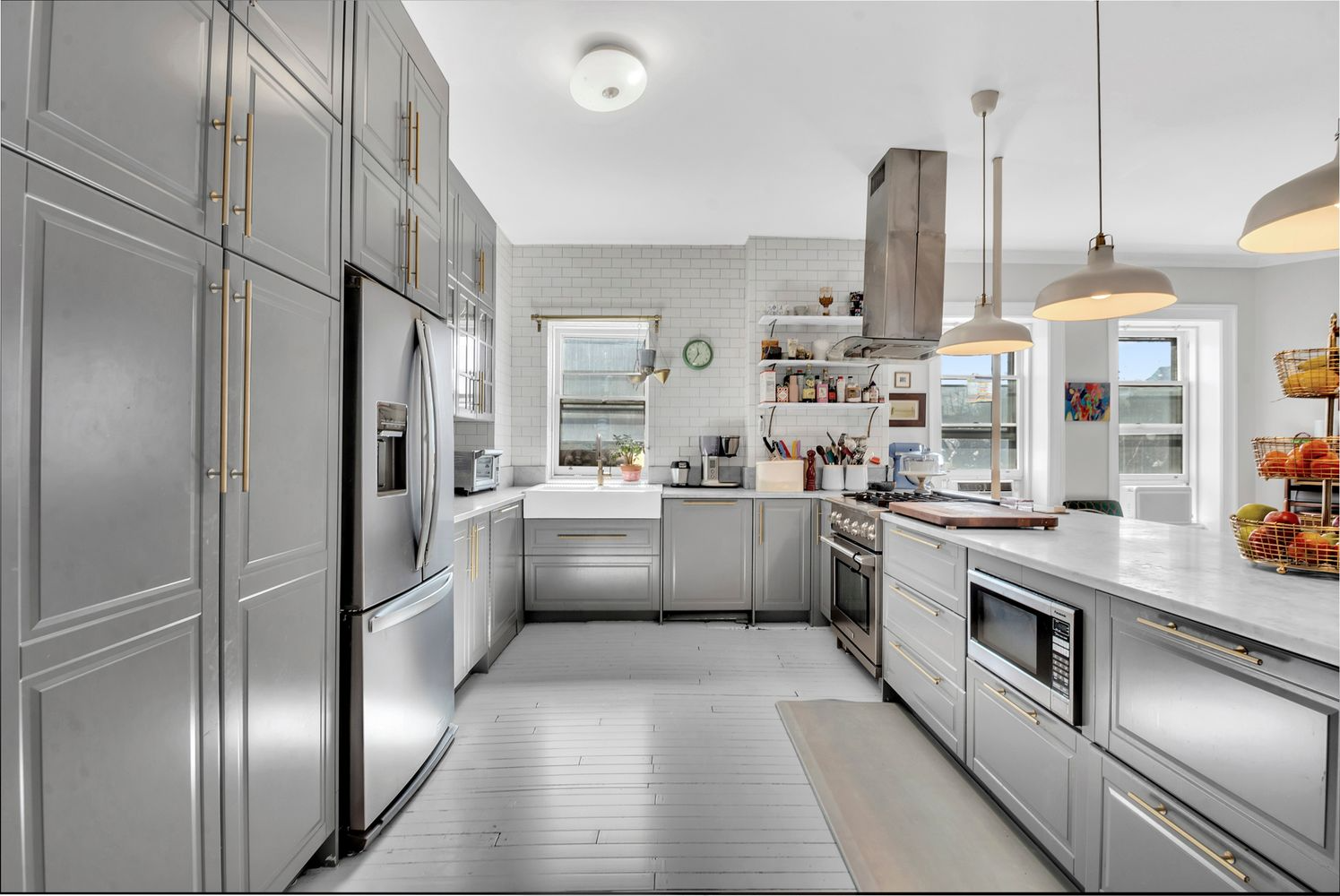 kitchen with gray cabinets, white subway tile on the walls
