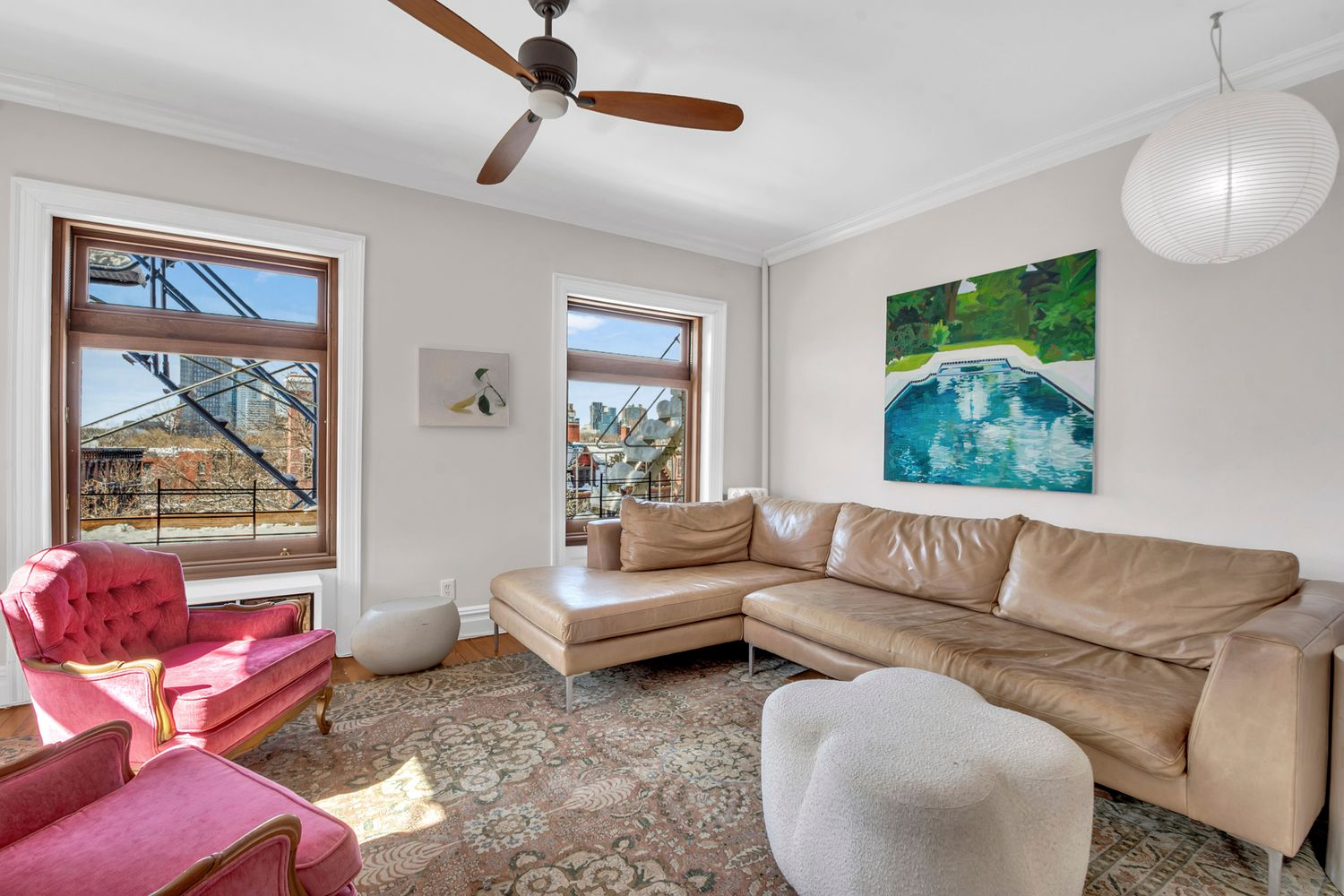 living room with white walls, ceiling fan